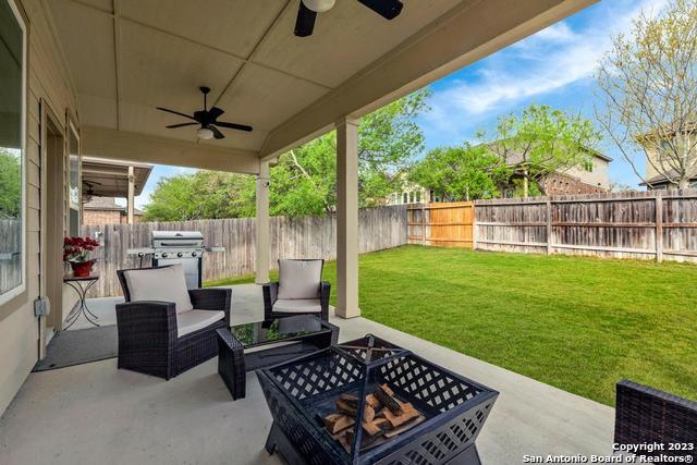 12515 Ponder Ranch San Antonio, TX 78245 - Photo 24 of 27 a view of a patio with a dining table and chairs