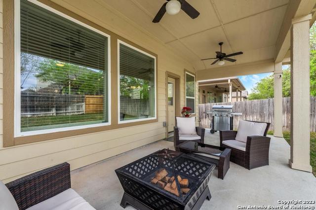 12515 Ponder Ranch San Antonio, TX 78245 - Photo 25 of 27 a living room with furniture and a floor to ceiling window