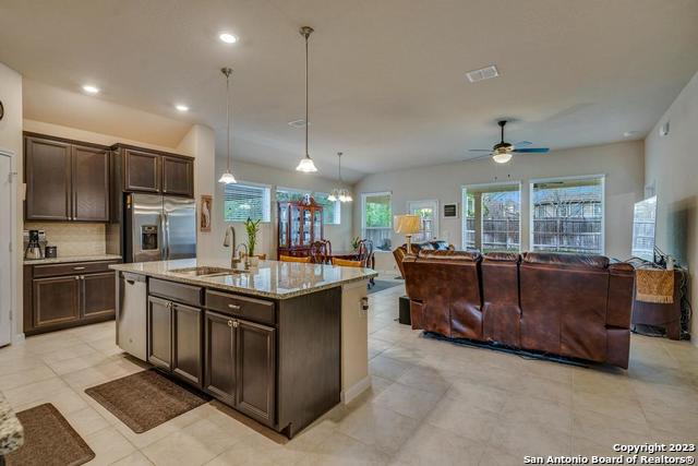 12515 Ponder Ranch San Antonio, TX 78245 - Photo 7 of 27 a kitchen with stainless steel appliances granite countertop a stove and a sink