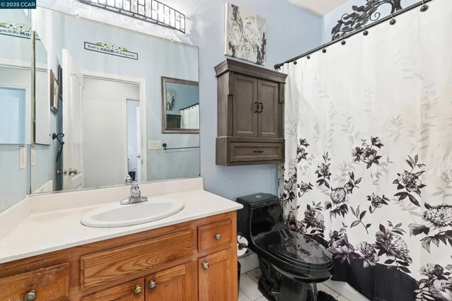 a bathroom with a sink and mirror with toilet