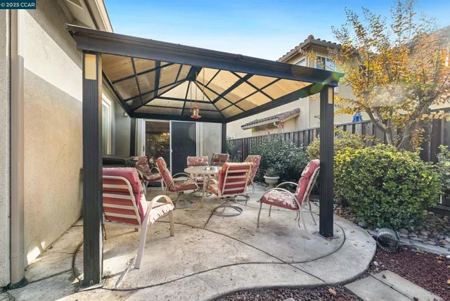 a backyard of a house with outdoor seating