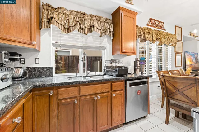 a kitchen with stainless steel appliances granite countertop a sink and cabinets