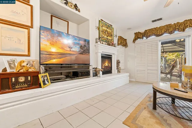 a living room with fireplace furniture and a flat screen tv