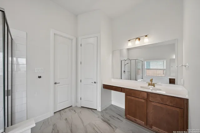 a bathroom with a double vanity sink and mirror