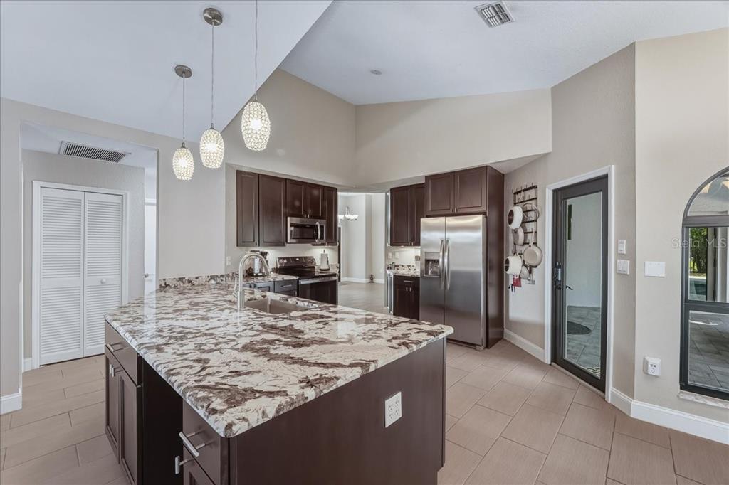 7314 Powder Puff Punta Gorda, FL 33955 - Photo 20 of 48 a kitchen with granite countertop kitchen island stainless steel appliances and refrigerator