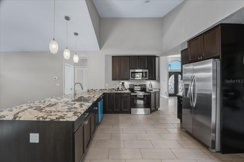 7314 Powder Puff Punta Gorda, FL 33955 - Photo 21 of 48 a large kitchen with stainless steel appliances granite countertop a sink stove and refrigerator