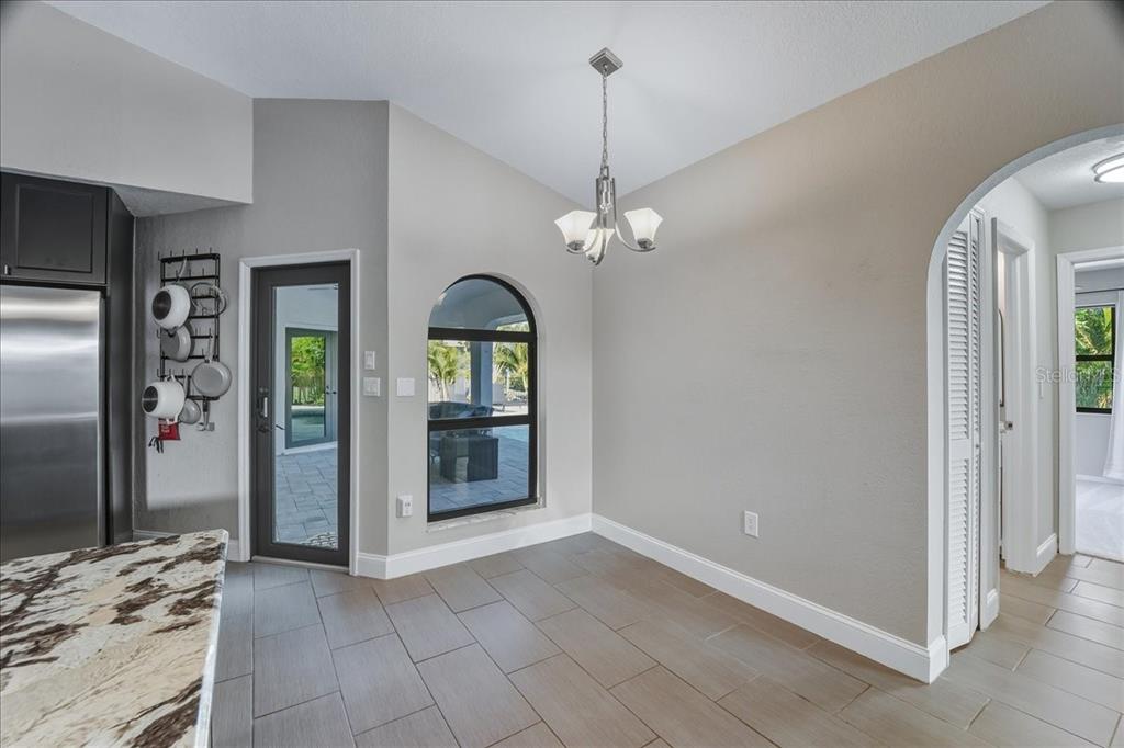 7314 Powder Puff Punta Gorda, FL 33955 - Photo 22 of 48 a view of a hallway with wooden floor and chandelier