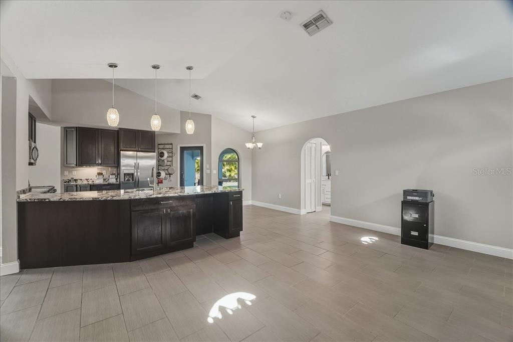 7314 Powder Puff Punta Gorda, FL 33955 - Photo 26 of 48 a large kitchen with stainless steel appliances kitchen island granite countertop a refrigerator a stove and a sink