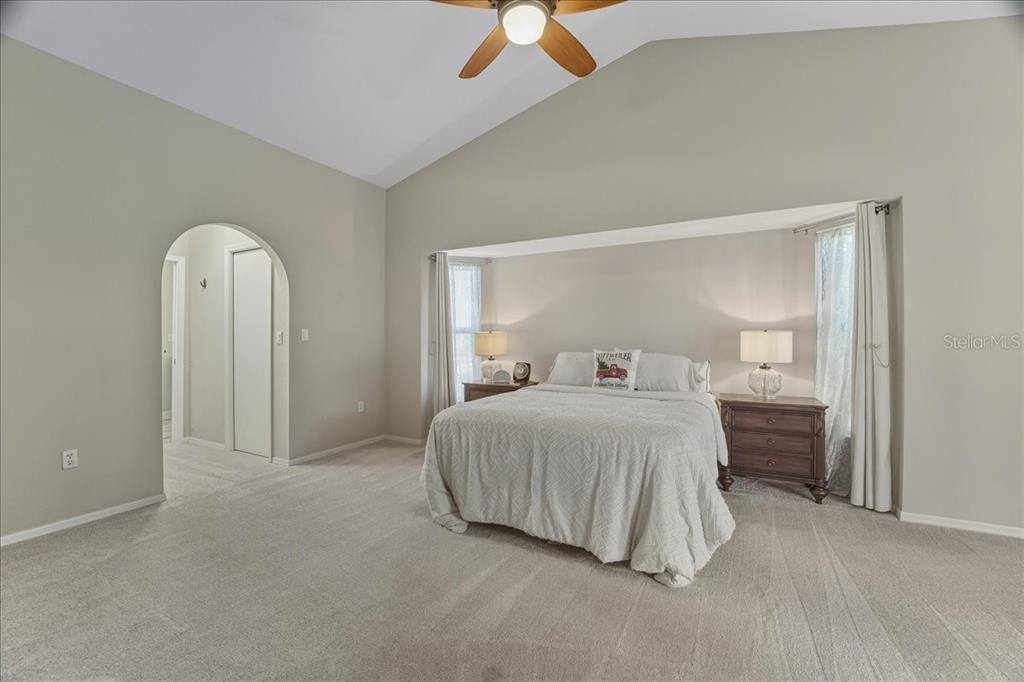 7314 Powder Puff Punta Gorda, FL 33955 - Photo 33 of 48 a spacious bedroom with a bed and a ceiling fan