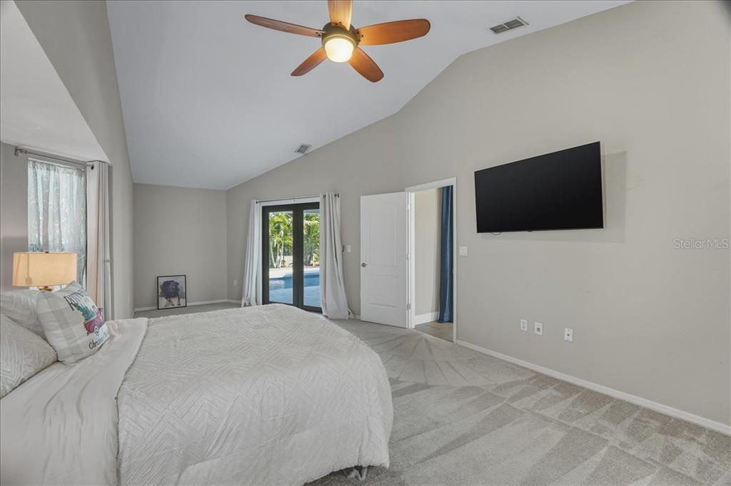 7314 Powder Puff Punta Gorda, FL 33955 - Photo 37 of 48 a bedroom with a bed and a flat screen tv