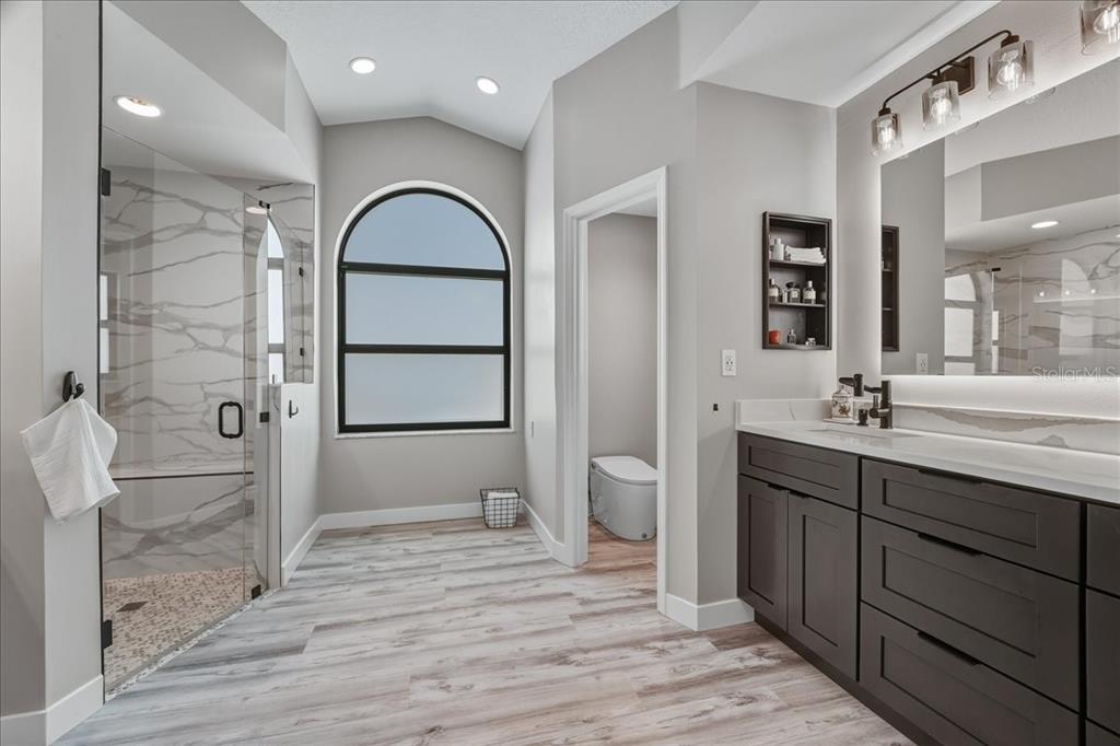 7314 Powder Puff Punta Gorda, FL 33955 - Photo 38 of 48 a spacious bathroom with a double vanity sink a mirror and a shower