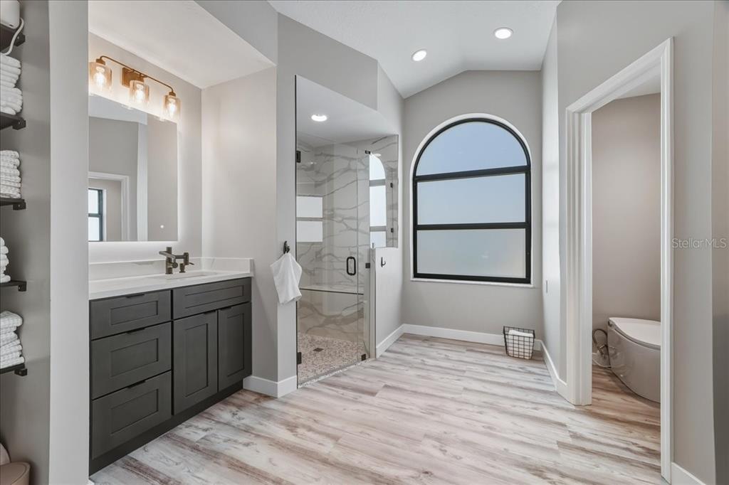 7314 Powder Puff Punta Gorda, FL 33955 - Photo 39 of 48 a spacious bathroom with a double vanity sink a toilet and a mirror