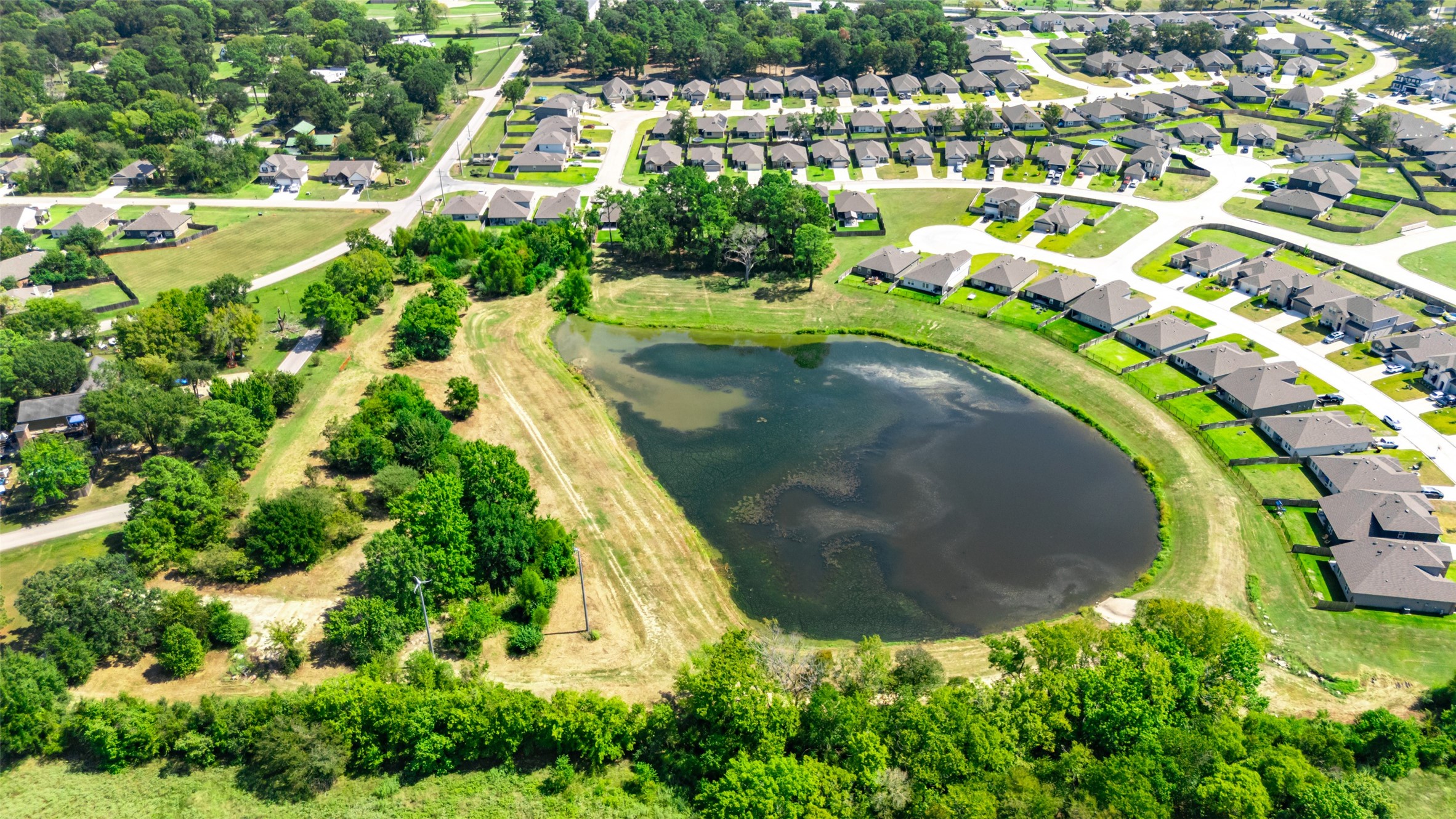 13015 Moon Road Willis, TX 77318 - Photo 4 of 12 an aerial view of residential houses with outdoor space and trees