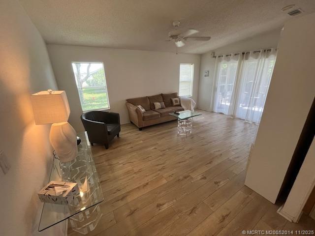 2671 Southwest Versailles Terrace Stuart, FL 34997 - Photo 6 of 9 a living room with furniture and a large window