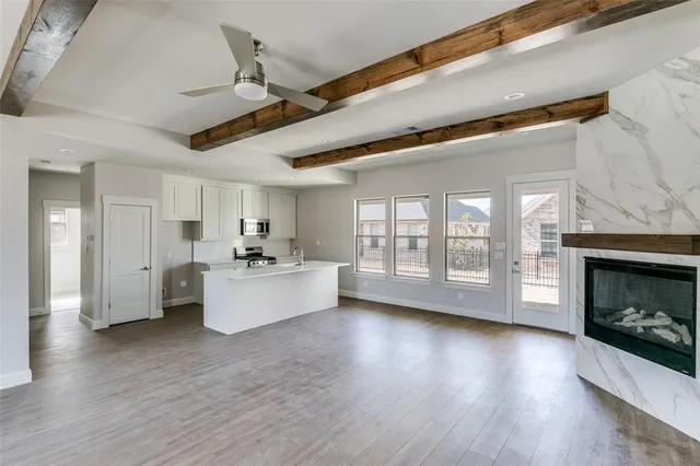 a large living room with a fireplace and wooden floor