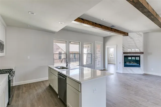 a spacious bathroom with a granite countertop sink and a large mirror