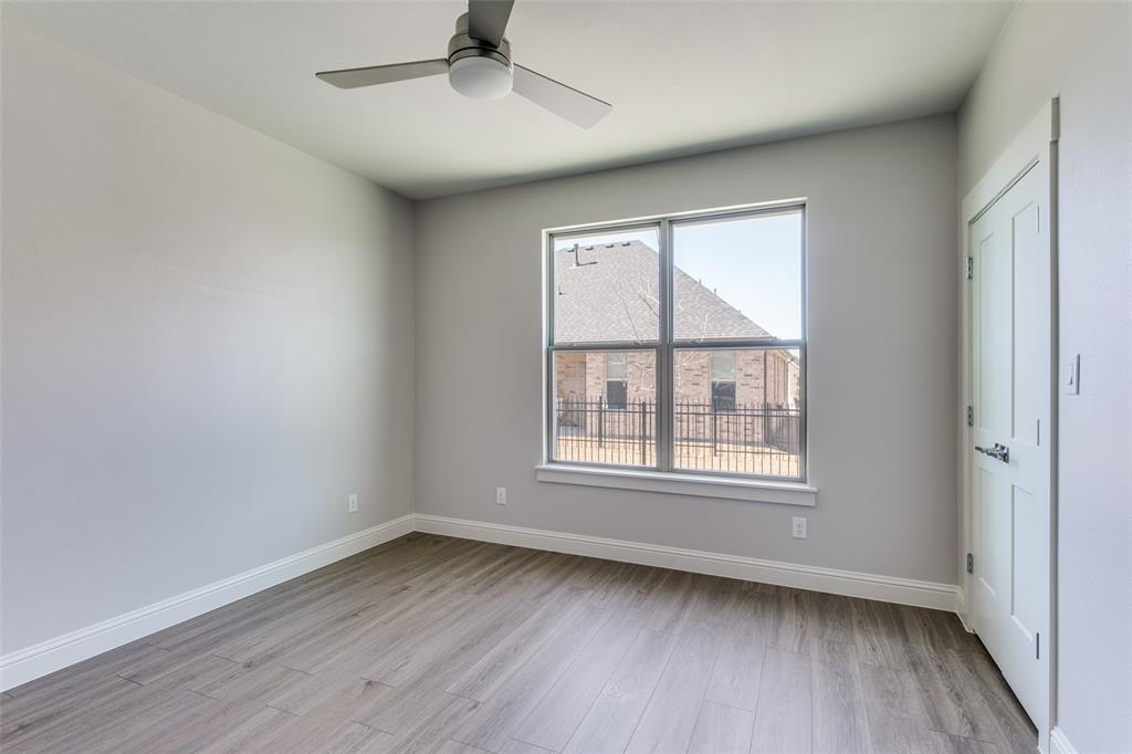 622 Community Lane Rockwall, TX 75087 - Photo 17 of 27 an empty room with wooden floor fan and windows