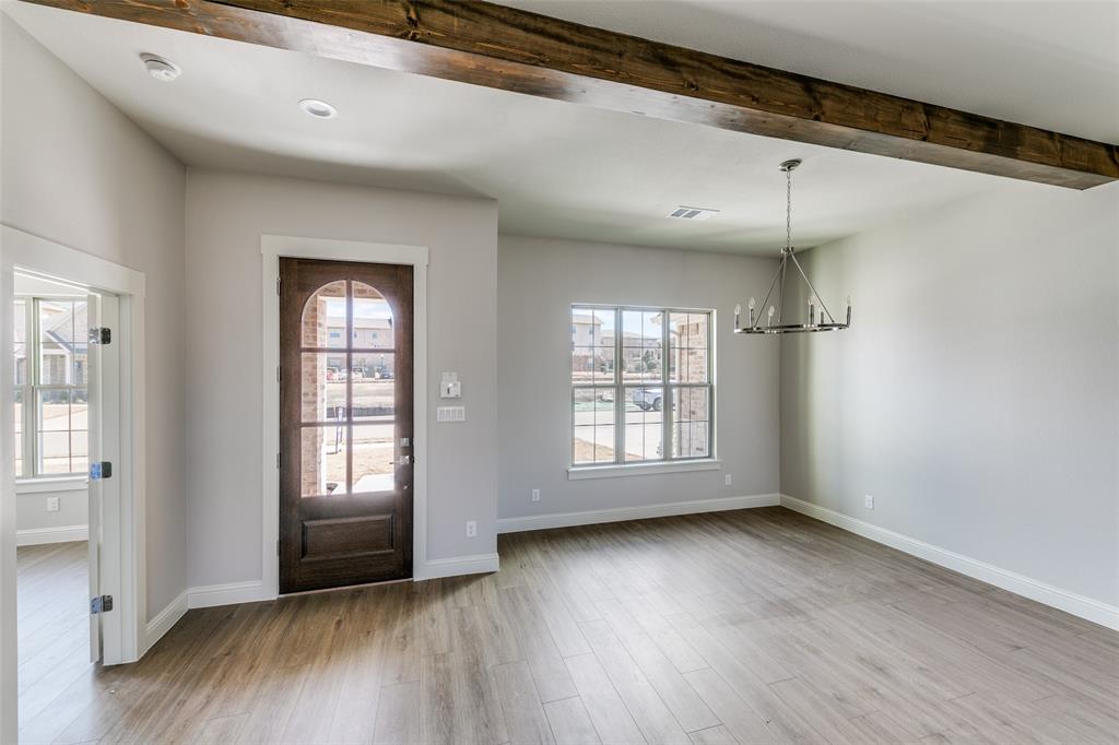 622 Community Lane Rockwall, TX 75087 - Photo 2 of 27 a view of an empty room with wooden floor and a window