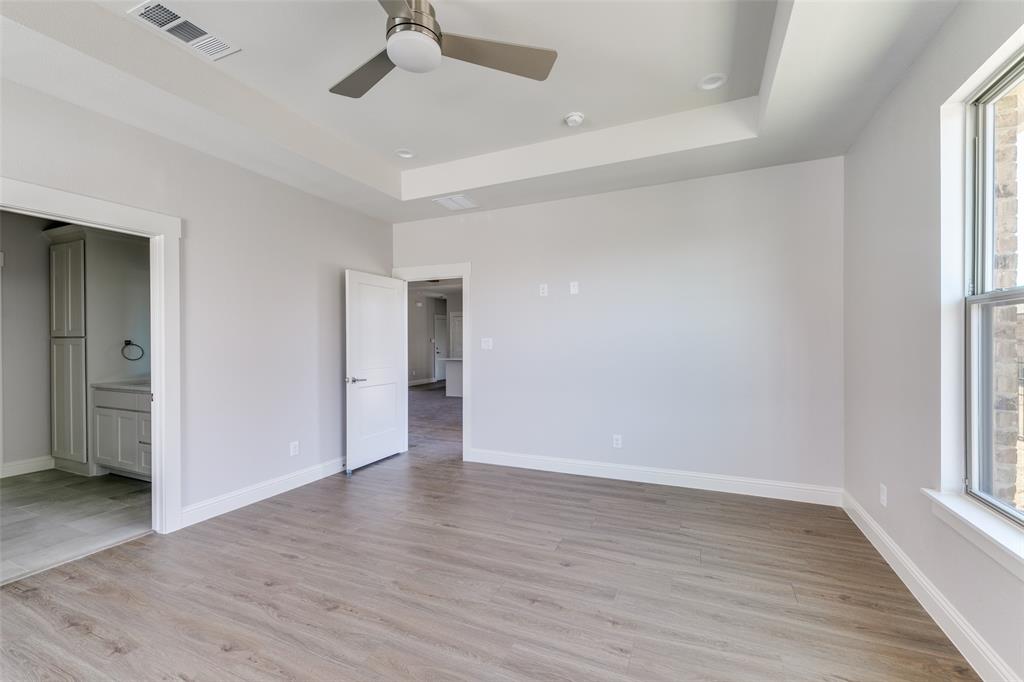 622 Community Lane Rockwall, TX 75087 - Photo 21 of 27 an empty room with wooden floor and windows