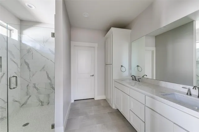 a bathroom with a double vanity sink and mirror