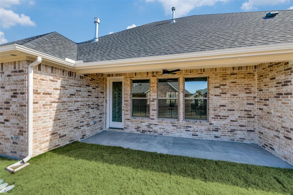 622 Community Lane Rockwall, TX 75087 - Photo 24 of 27 front view of a house with a yard
