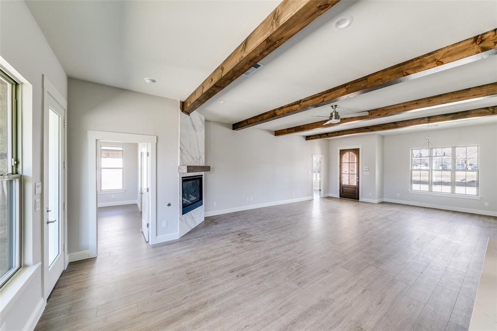 622 Community Lane Rockwall, TX 75087 - Photo 5 of 27 a view of a big room with wooden floor and windows