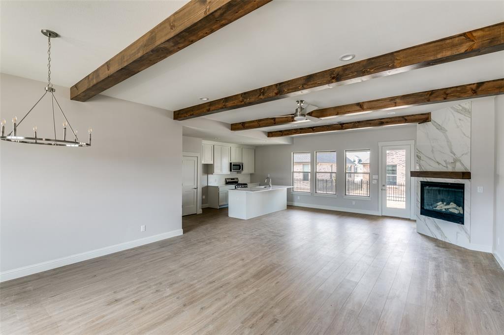 622 Community Lane Rockwall, TX 75087 - Photo 9 of 27 a view of a room with wooden floor fireplace and windows