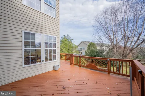 a view of balcony with wooden floor and fence