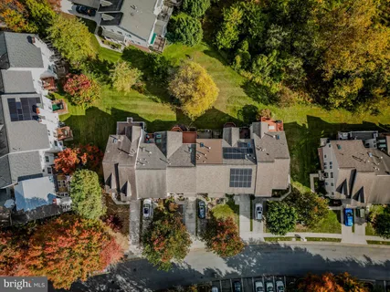 an aerial view of a house with a yard basket ball court and outdoor seating