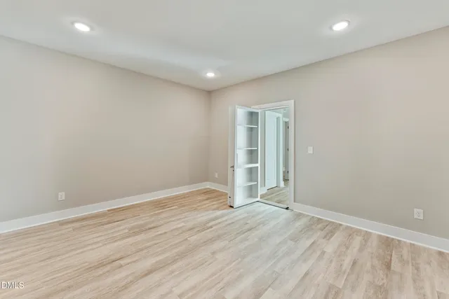 an empty room with wooden floor
