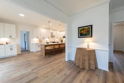 a spacious bedroom with a bed and a chandelier