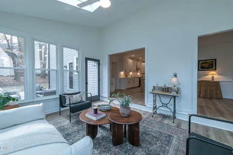 a front view of a house with a garden and trees