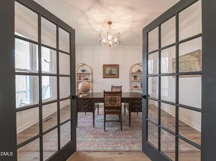 a view of a workspace with furniture window and wooden floor