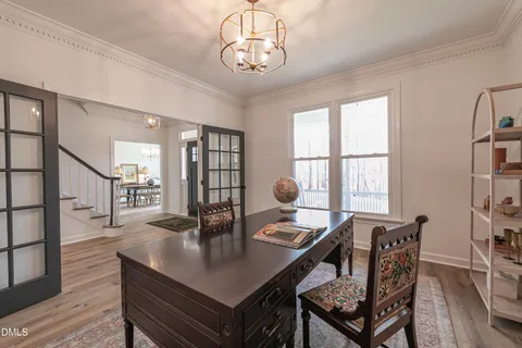 a view of a dining room with furniture and chandelier
