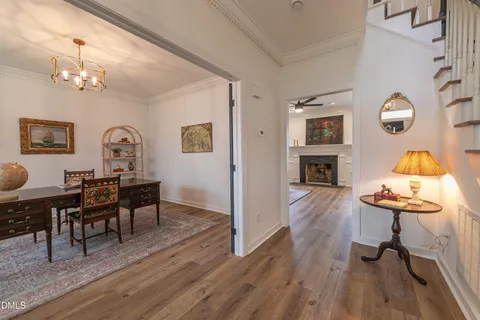 a living room with furniture a fireplace and wooden floor