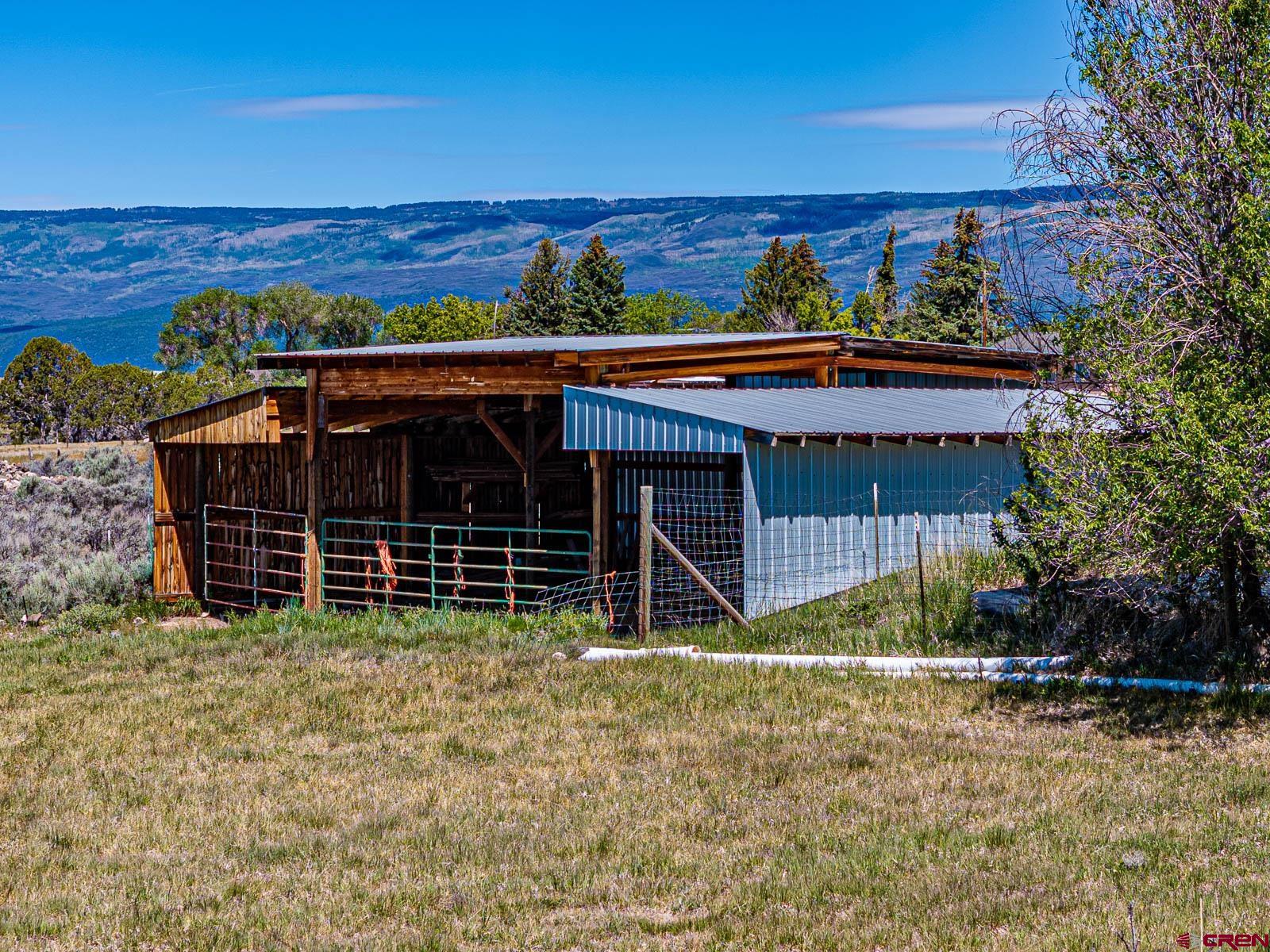 16331 2550th Road Cedaredge, CO 81413 - Photo 42 of 45 a view of a house with a yard and a large tree