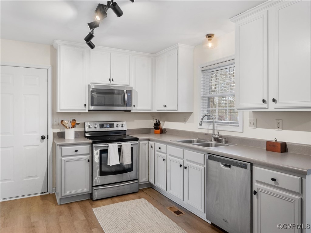 3640 Markey Road Midlothian, VA 23112 - Photo 23 of 42 a kitchen with stainless steel appliances a sink stove and microwave