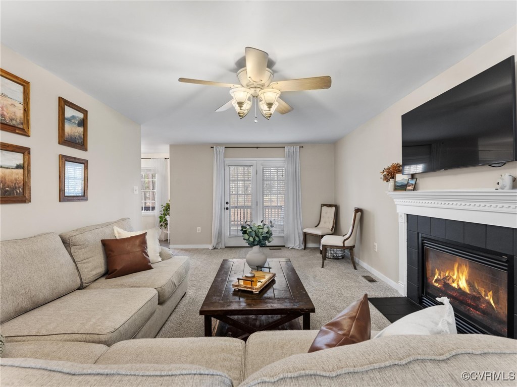 3640 Markey Road Midlothian, VA 23112 - Photo 26 of 42 a living room with furniture a flat screen tv and a fireplace