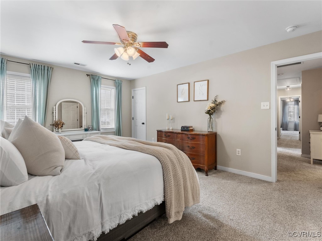 3640 Markey Road Midlothian, VA 23112 - Photo 30 of 42 a bedroom with a large bed and a chandelier
