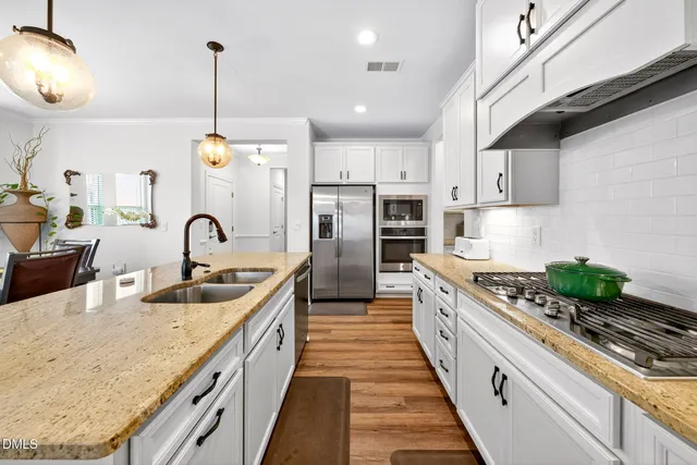 a kitchen with stainless steel appliances a stove a microwave and cabinets