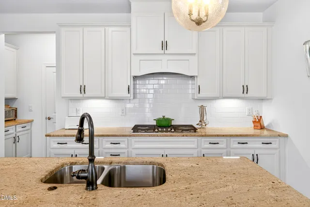 a bathroom with a granite countertop sink toilet a mirror and shower