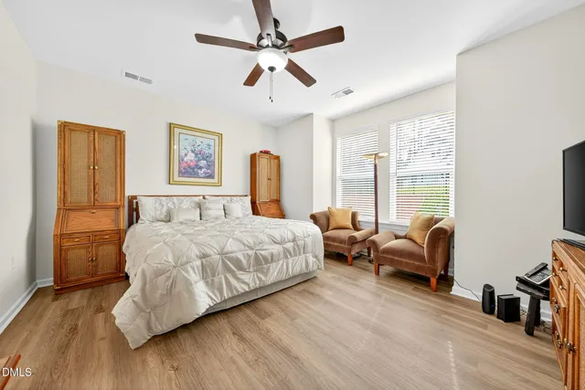 a view of a white house with a large pool and a yard in front of it