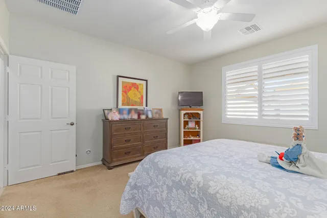 a bedroom with a bed and a dresser