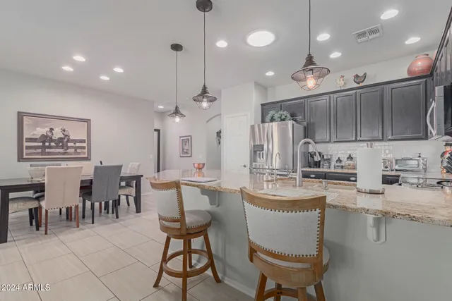 a large kitchen with a table and chairs