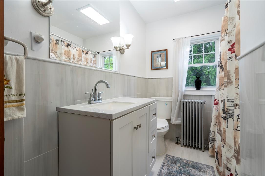 665 Point Phillips Road Bath, PA 18014 - Photo 36 of 73 A well-appointed bathroom features a bright vanity, window views, and light-toned tile work.