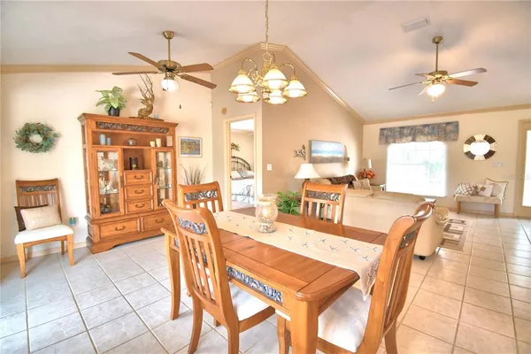 a view of a dining room with furniture wooden floor and chandelier