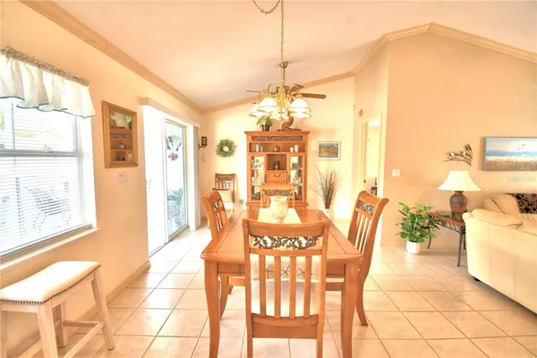 a view of a dining room with furniture and a chandelier