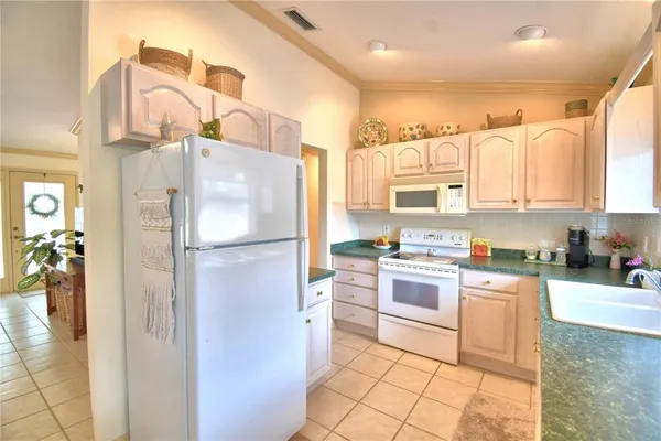 a kitchen with a refrigerator a sink and a stove top oven