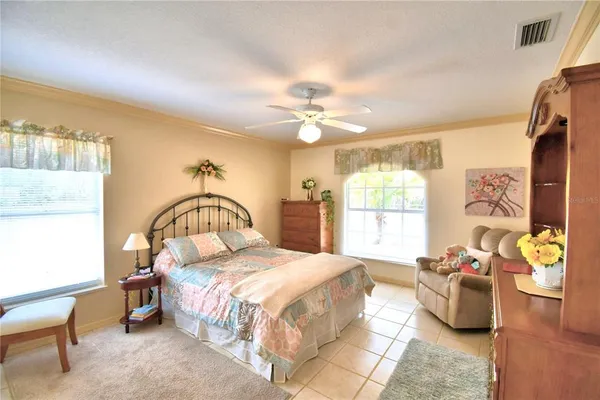 a bedroom with a bed couch and window