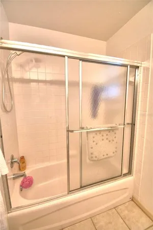 a bathroom with a bathtub and a shower